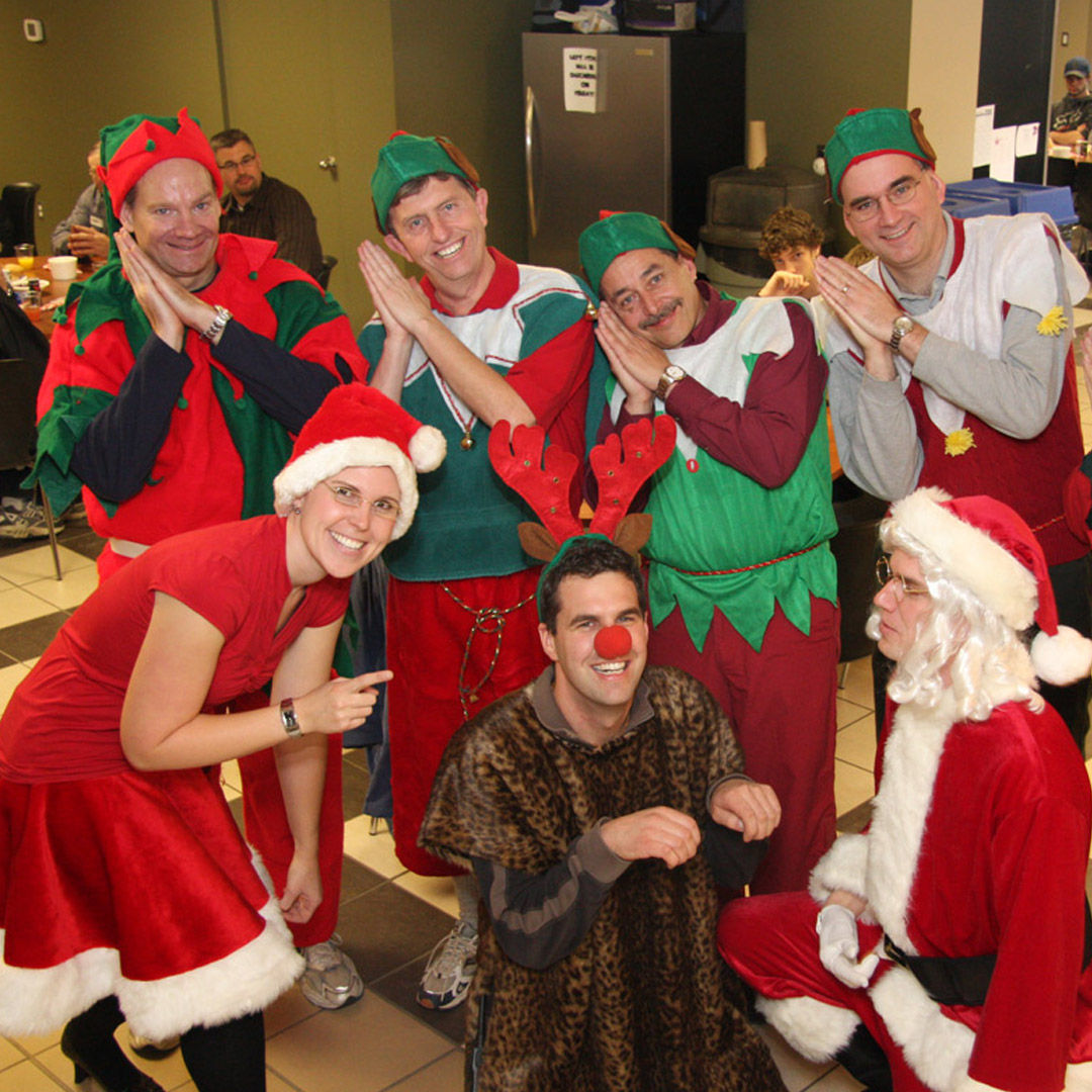 group of people dressed up as elves, santa, and a reindeer